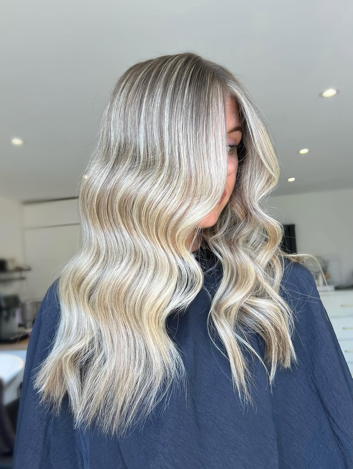 46. Creamy Blonde Waves with Bright Face-Framing Highlights