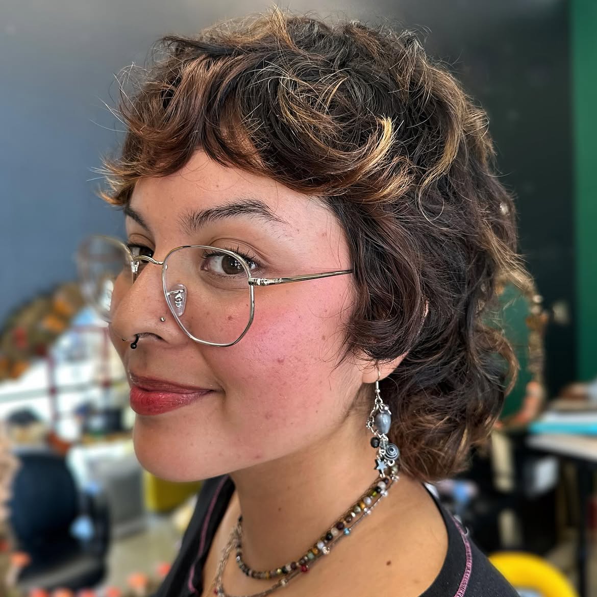 6. Curly Brunette Pixie Mullet with Caramel Streaks