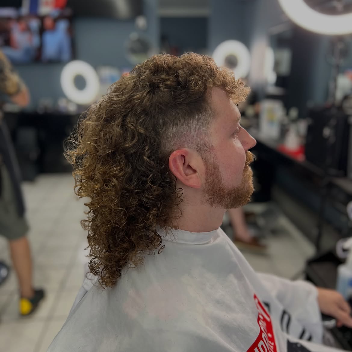 3. Curly Burst Fade Mullet