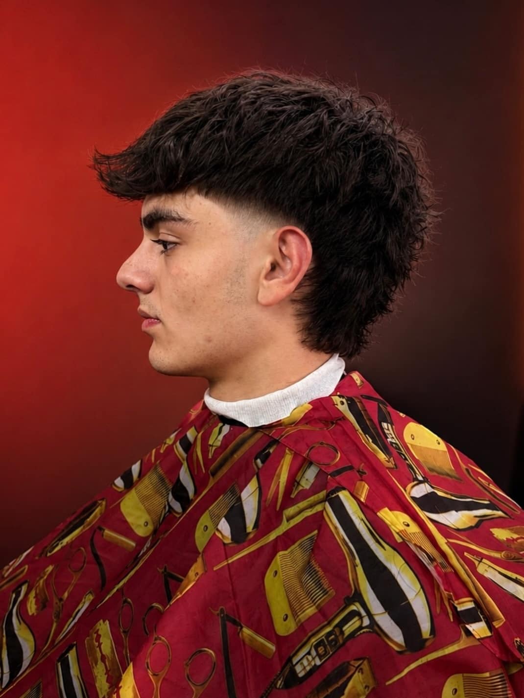 16. Curly Edgar Mullet with Low Taper Fade