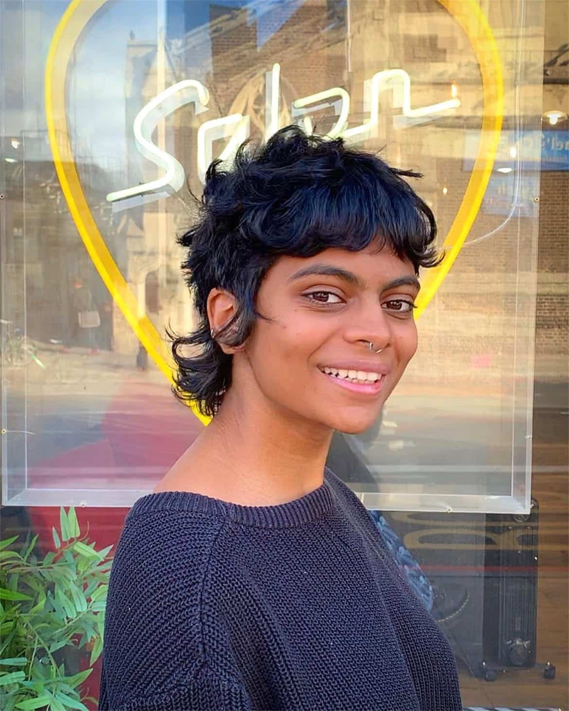 4. Curly Fringe Pixie Mullet with Flipped Nape