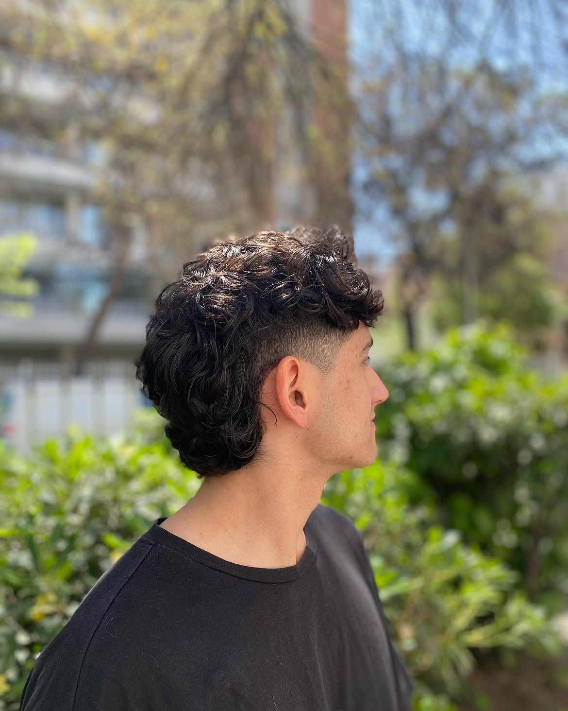 42. Curly Low Fade Mullet with Full Top
