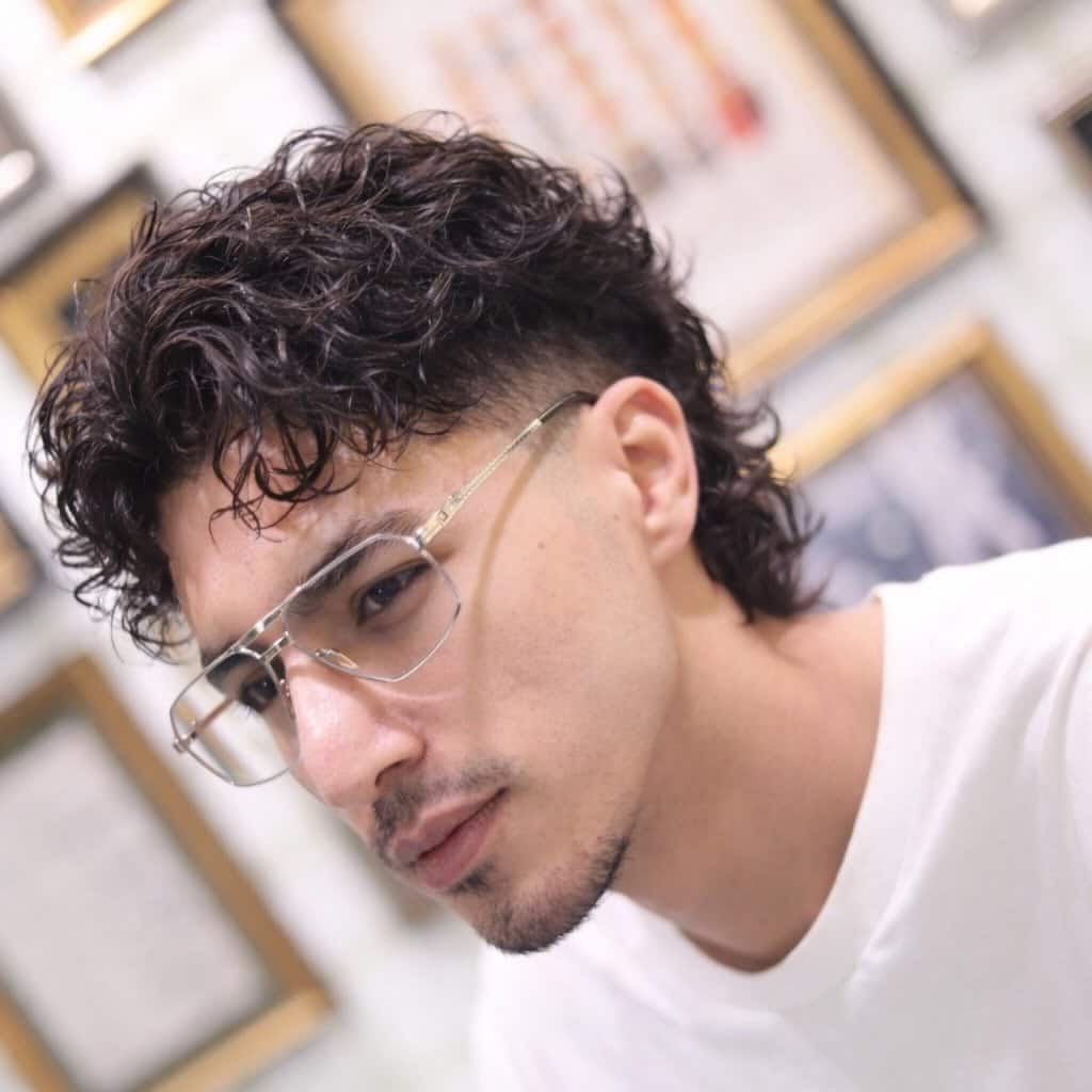 42. Curly Mullet with High Skin Fade