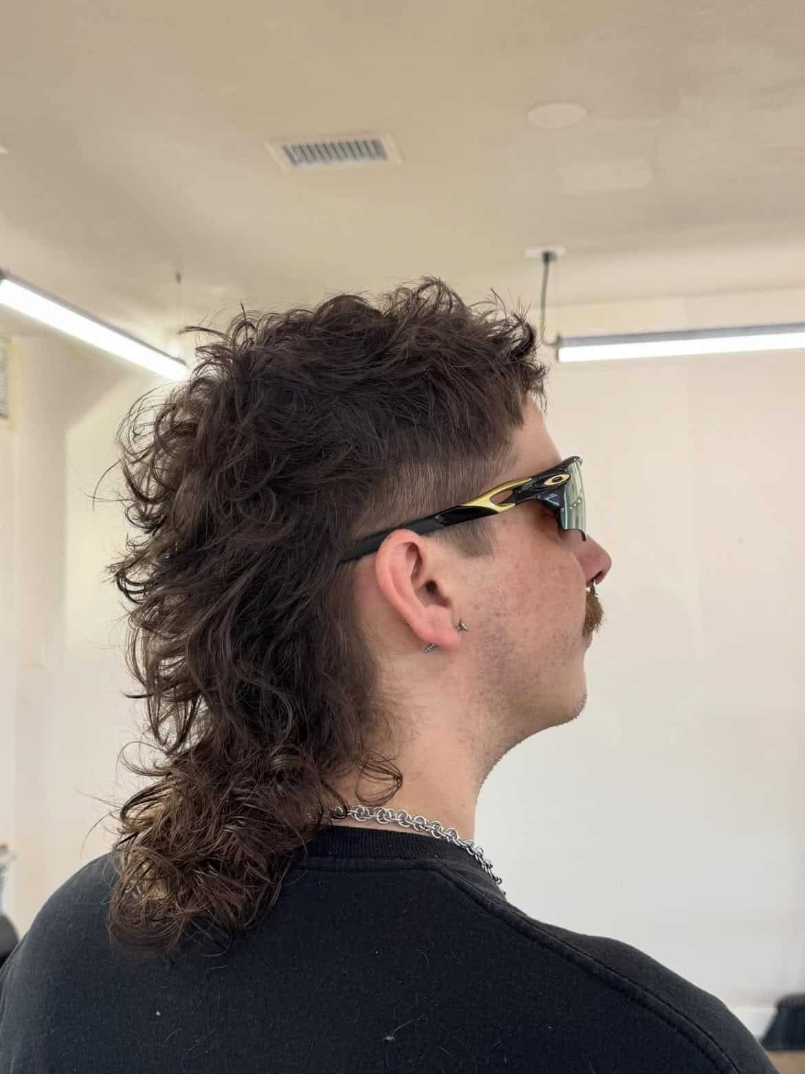 23. Curly Mullet with Tapered Sides and Long Nape