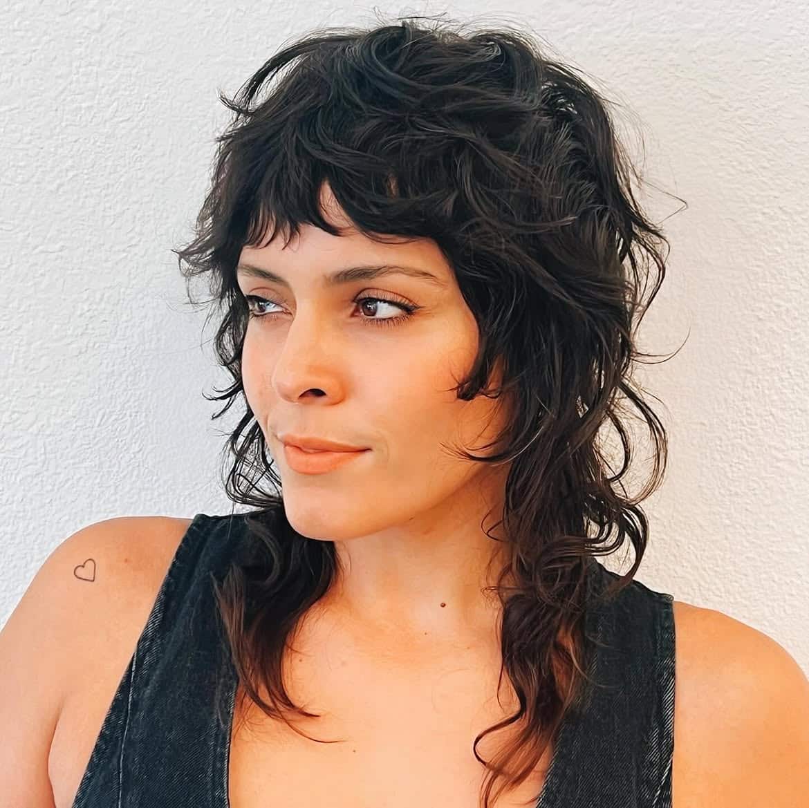 31. Curly Shag Mullet with Baby Bangs
