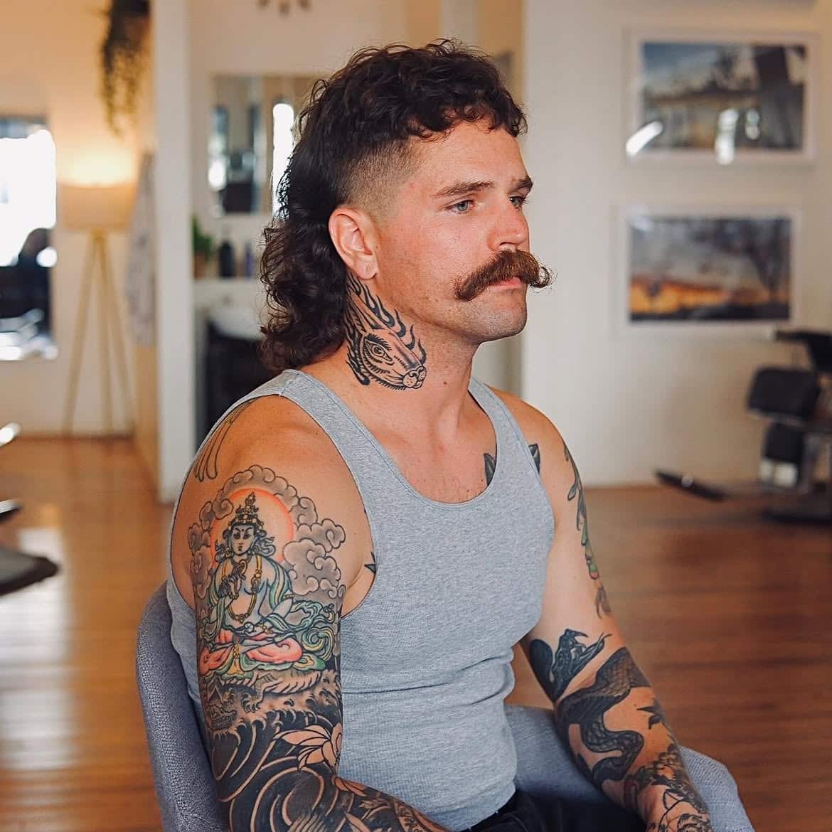 40. Curly Skin Fade Mullet with Short Fringe