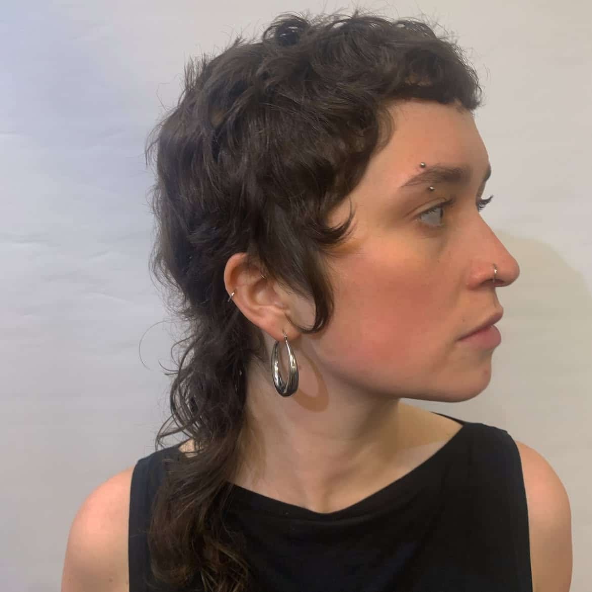 30. Dark Brown Curly Mullet with Baby Bangs