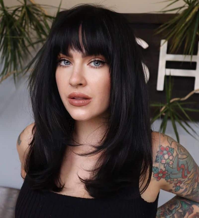 4. Feathered Layers with Full Bangs