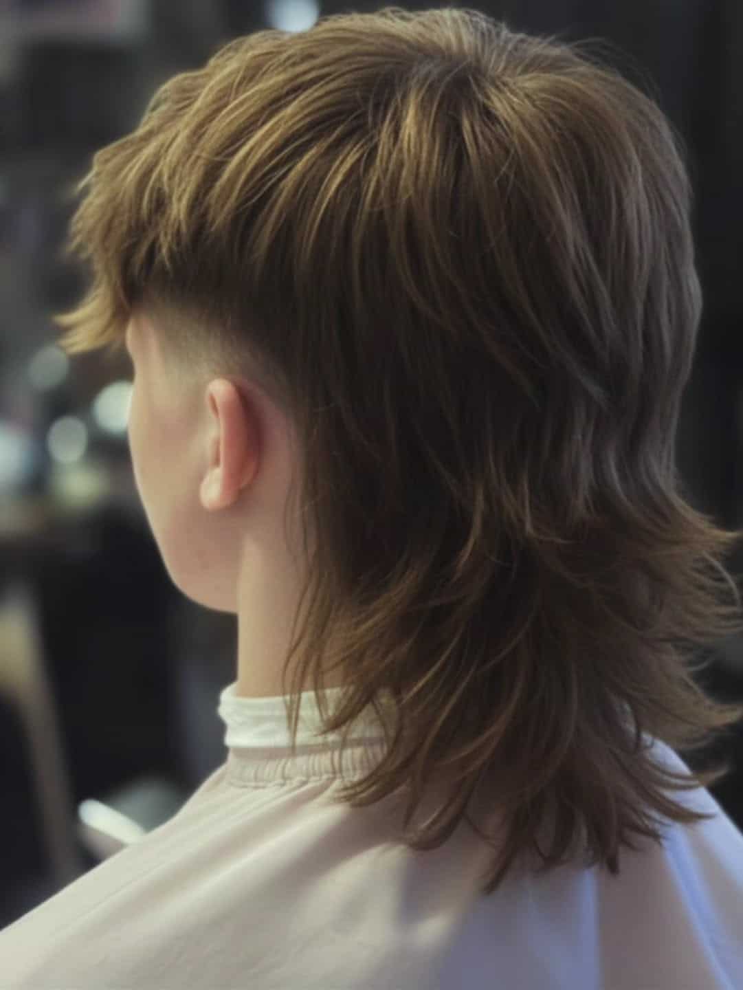 4. Feathered Mullet Fade with Tapered Sides