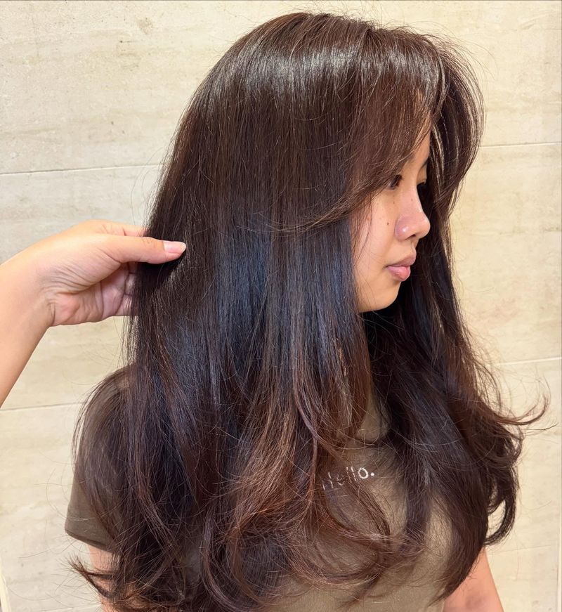 28. Glossy Chestnut Layers with Soft Curtain Bangs