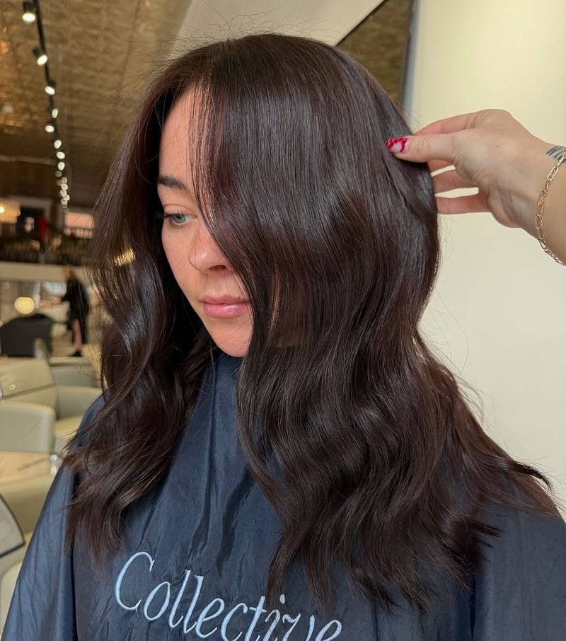 25. Glossy Espresso Waves with Wispy Fringe