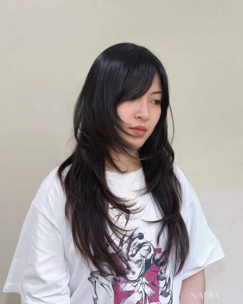 43. Glossy Jet Black Long Wolf Cut with Side Swept Bangs