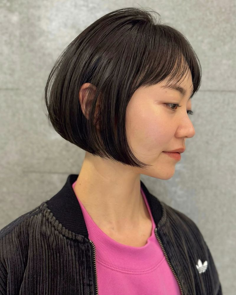 43. Glossy Rounded Bob with Wispy Bangs