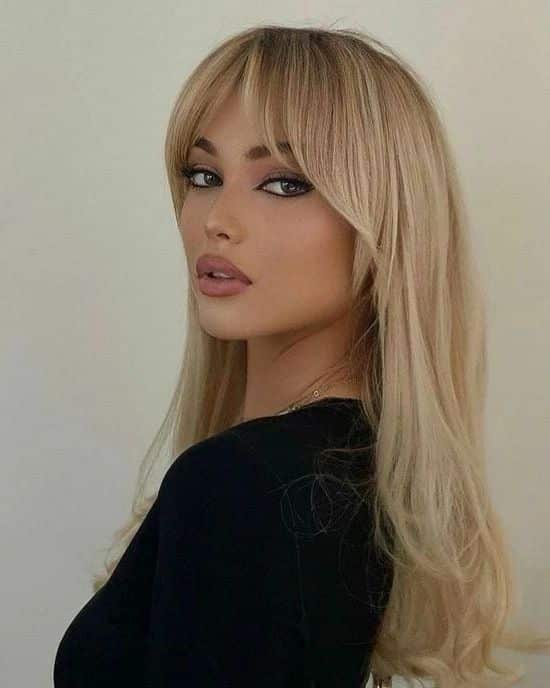 66. Golden Blonde Curtain Bangs with Long Layers