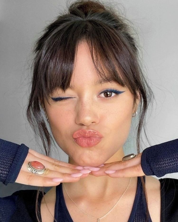 16. High Bun with Wispy Face-Framing Tendrils