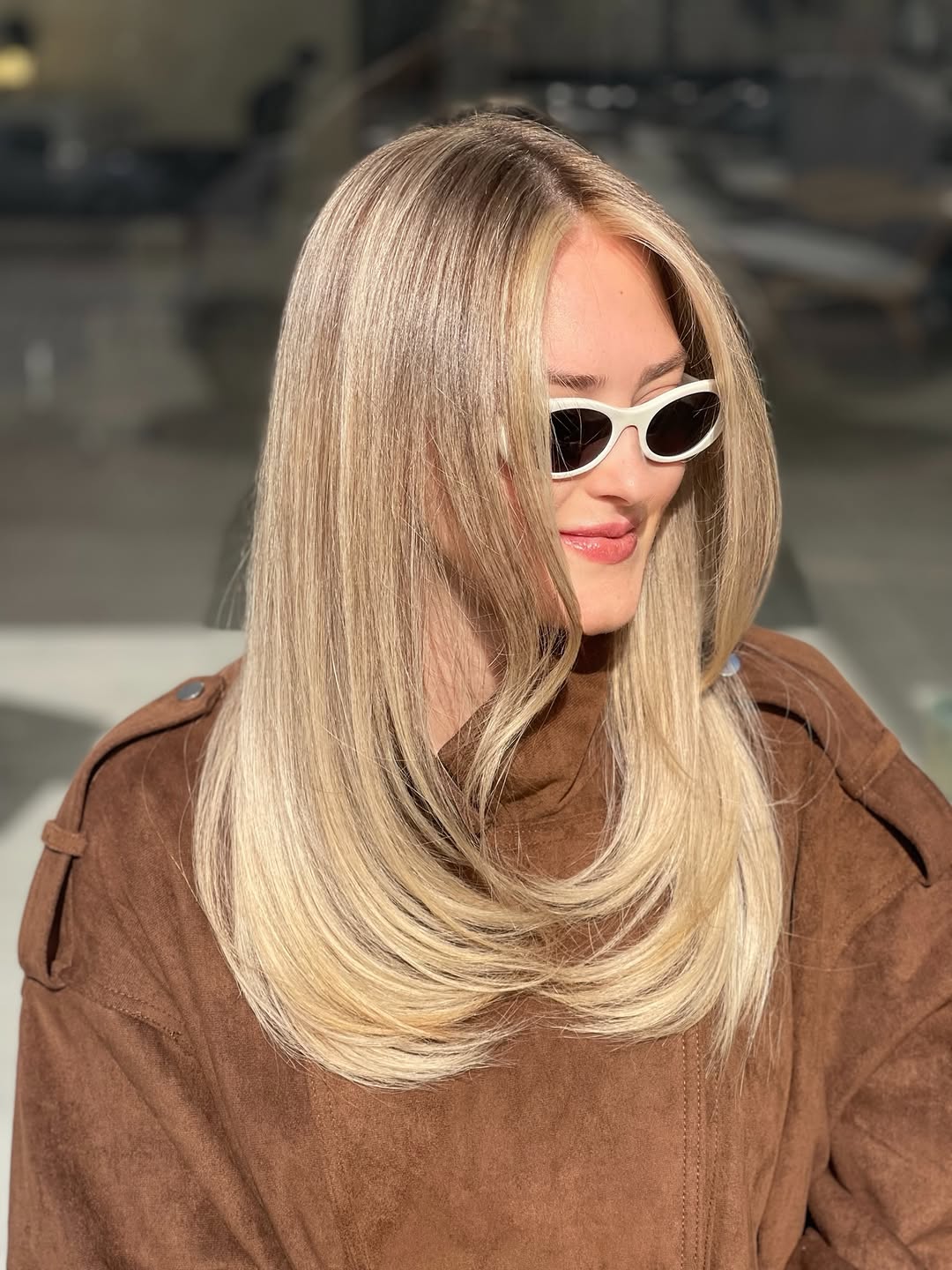 15. Honey Blonde Butterfly Layers with Bright Face-Framing Highlights