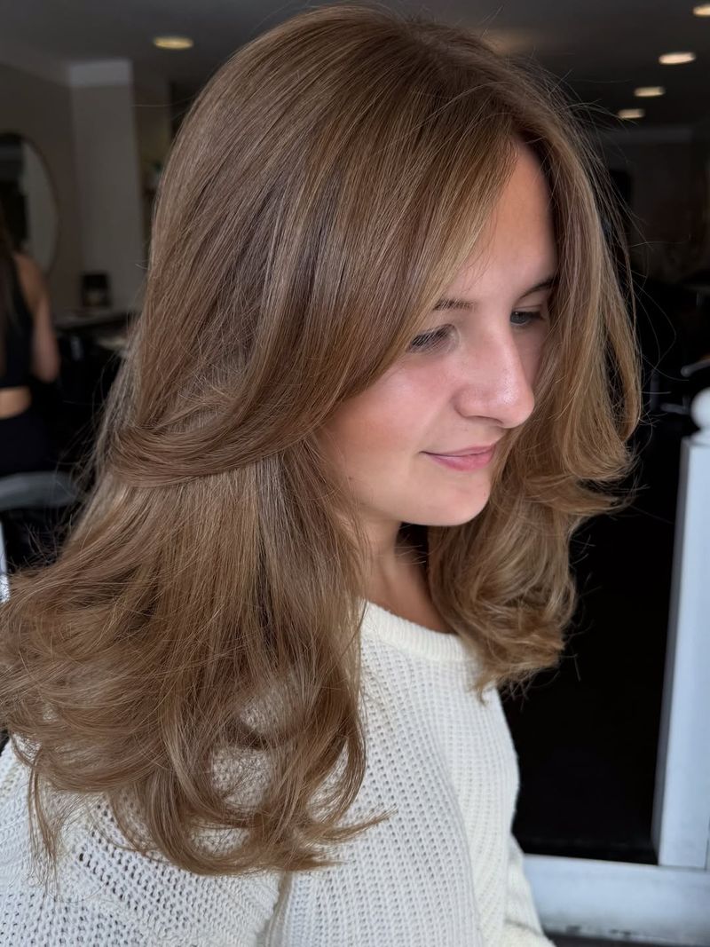 69. Honey Caramel Blowout with Curtain Bangs