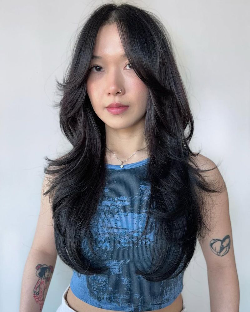 13. Jet Black Layers with Curtain Bangs