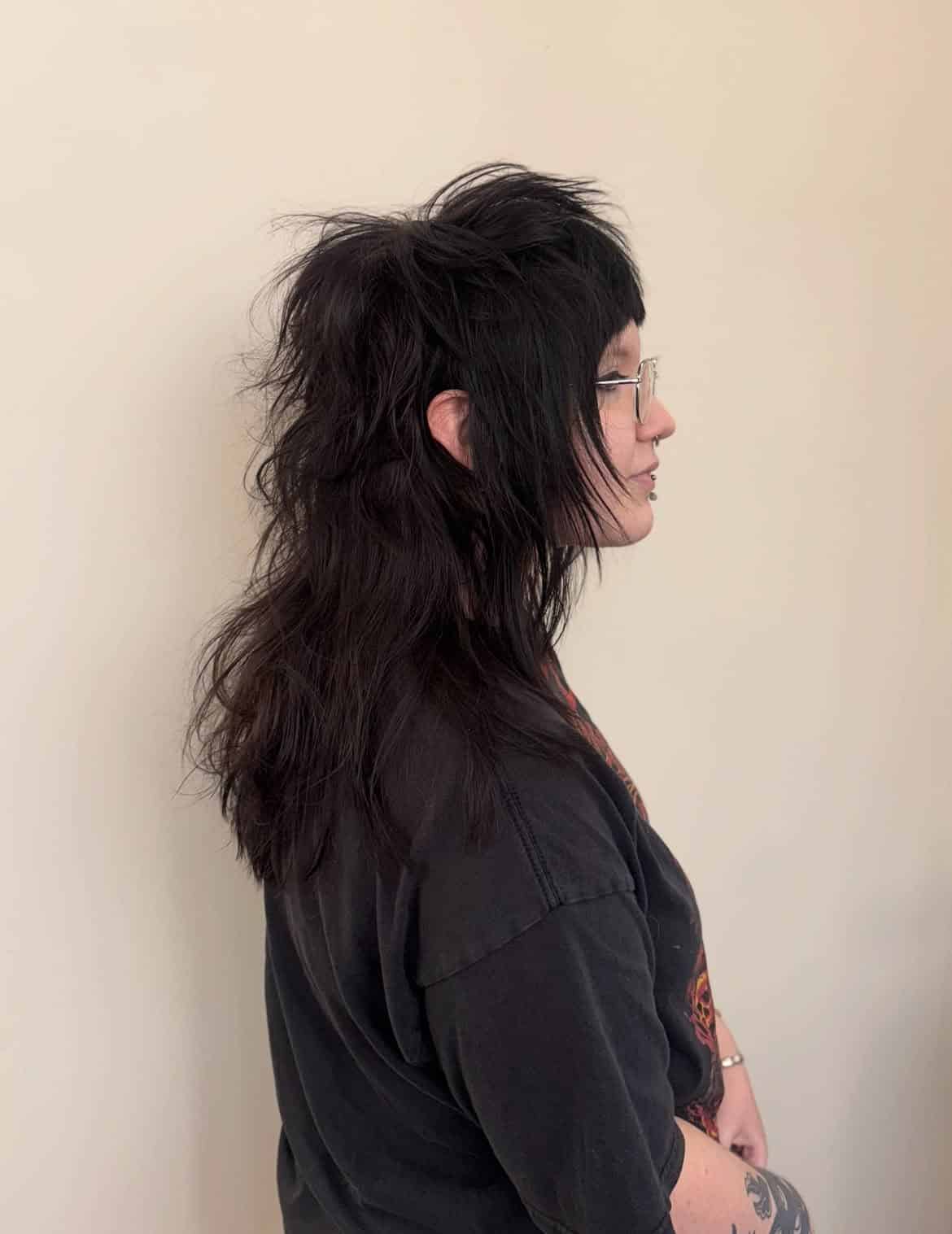 42. Jet-Black Razor Shag Mullet with Baby Bangs