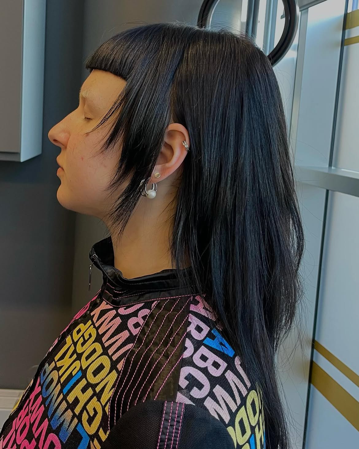 27. Jet Black Shaggy Mullet with Micro Bangs