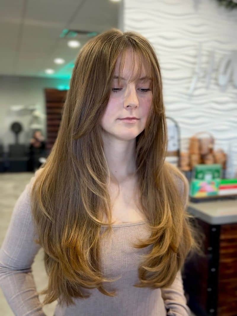 53. Long Layered Chestnut Hair with Wispy Curtain Bangs