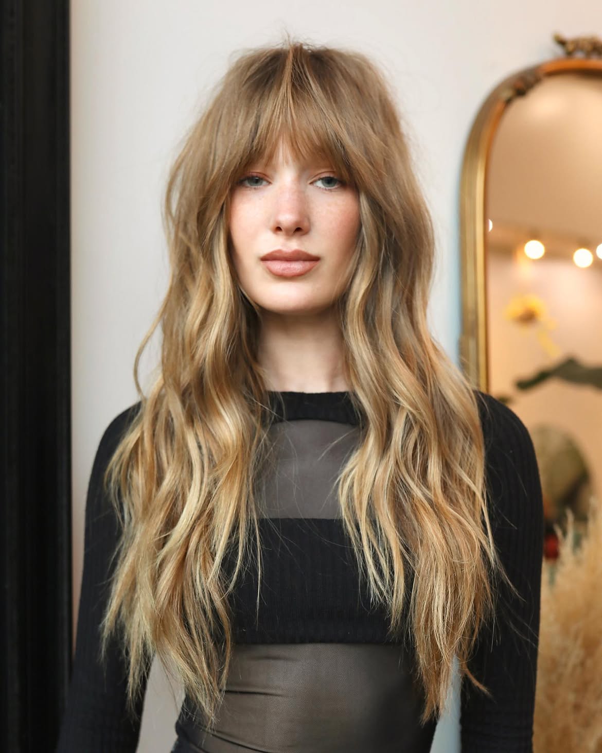 17. Long Shag with Wispy Bangs and Honey Blonde Waves