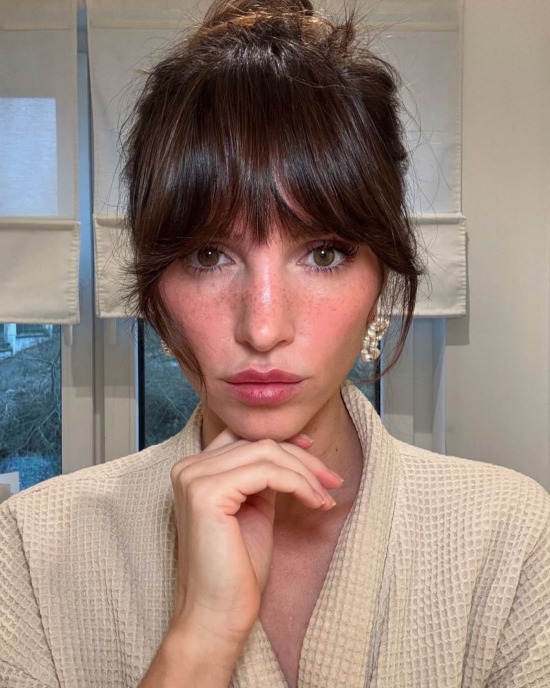 40. Messy Topknot with Full Fringe