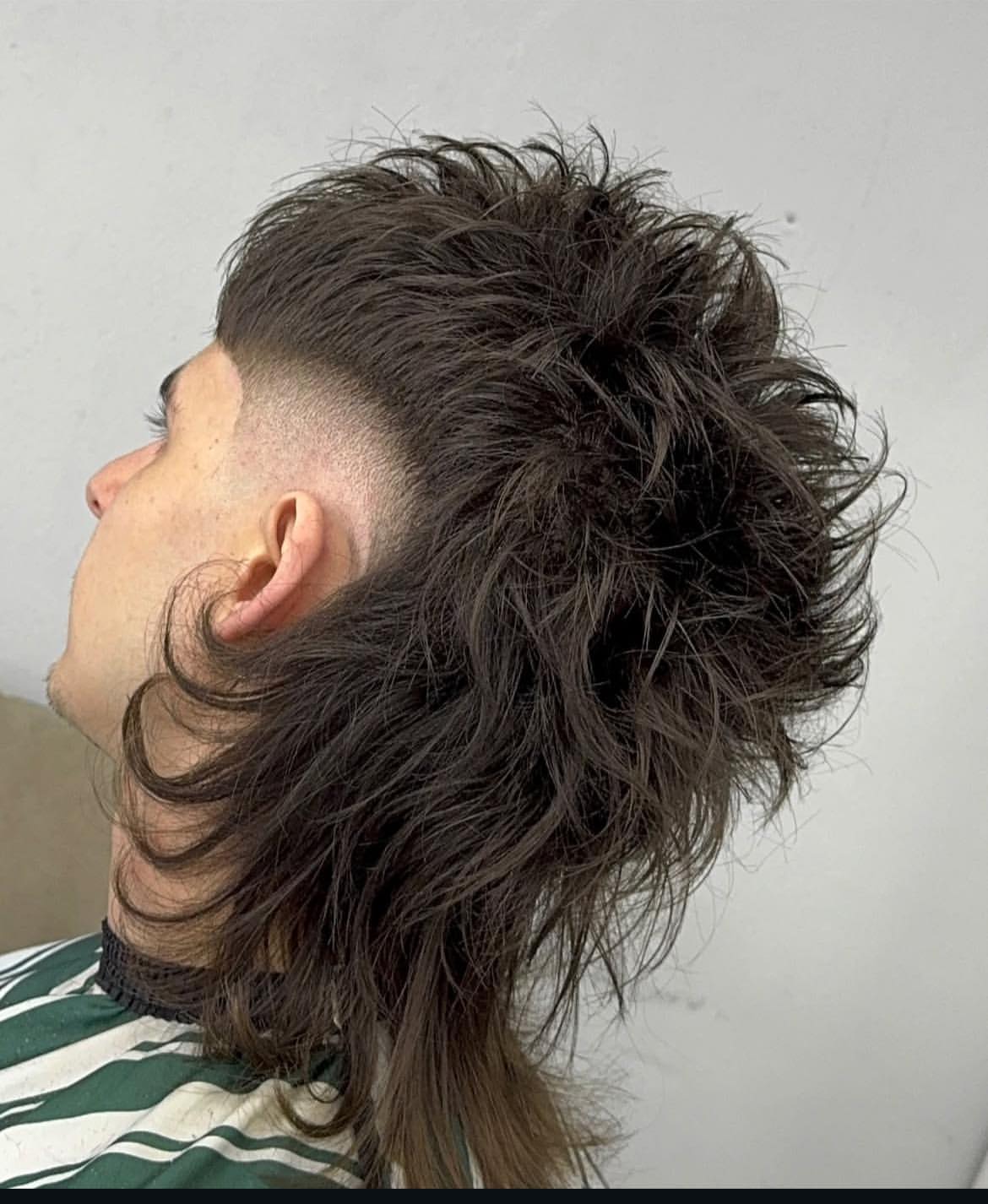 12. Messy Wavy Mullet with High Skin Fade