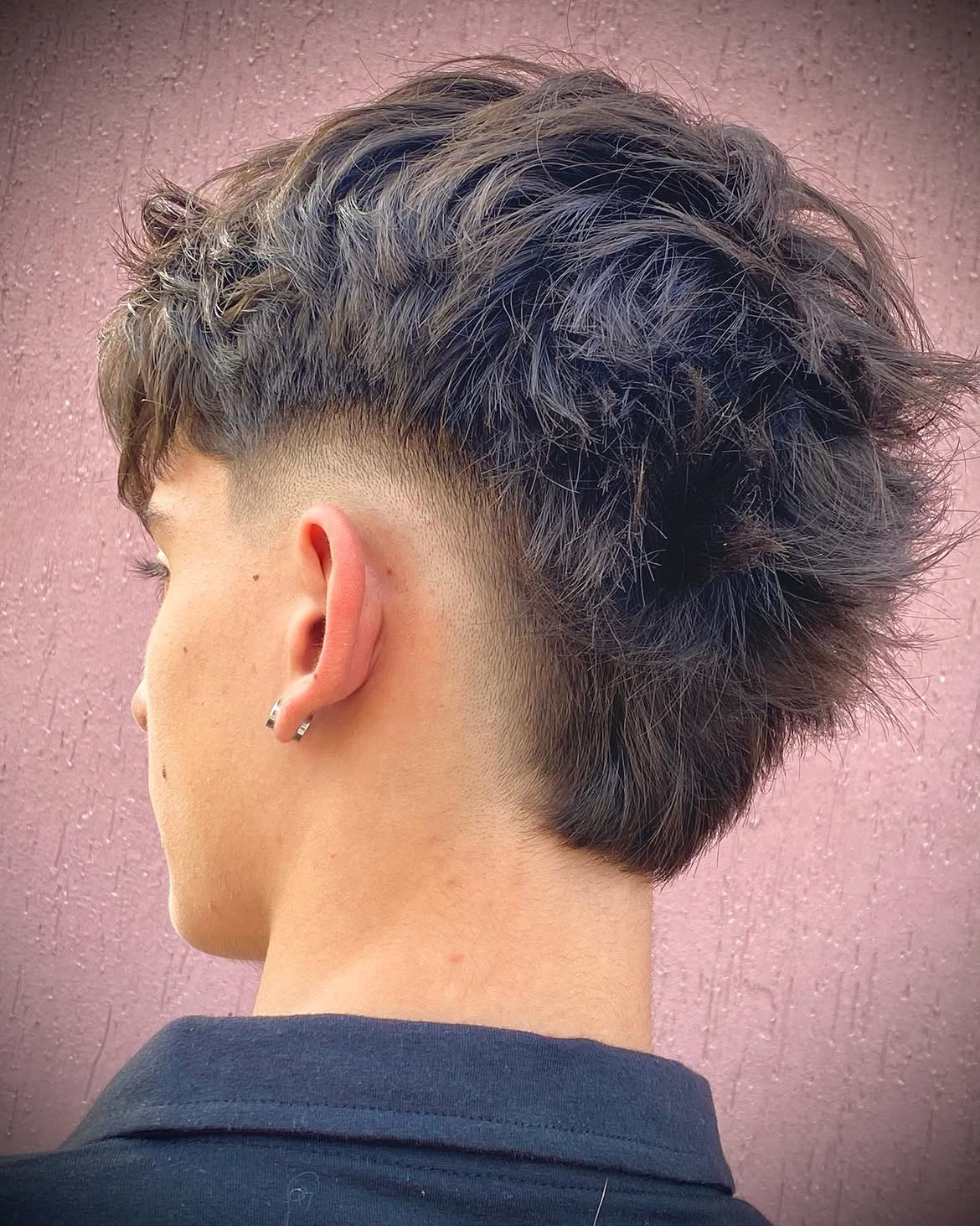 7. Messy Wavy Mullet with a Tight Burst Fade