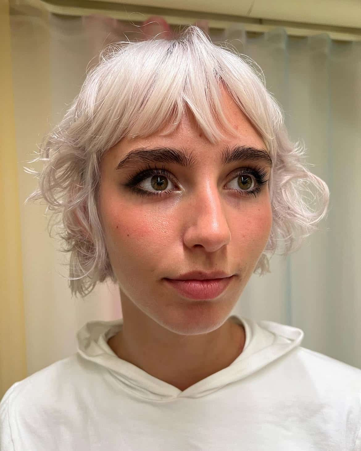38. Platinum Curly Pixie Mullet with Wispy Bangs