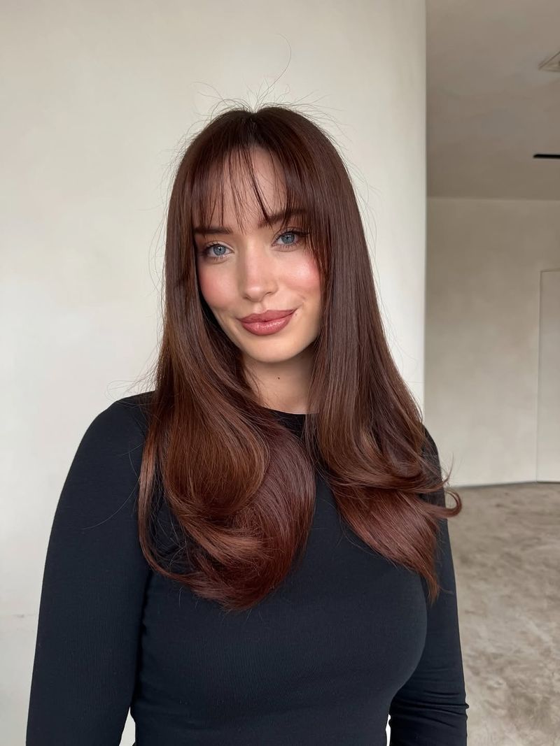37. Polished Chestnut Layers with Wispy Bangs