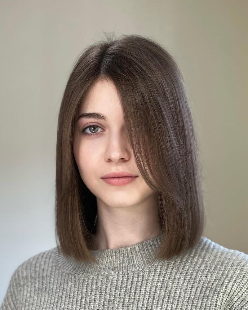 24. Polished Espresso Lob with Side-Swept Fringe