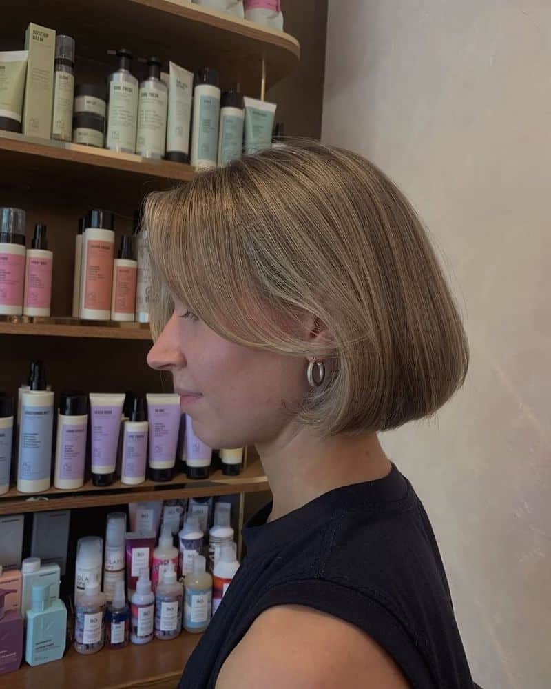10. Rounded Ash Blonde Bob with Curved Side Fringe