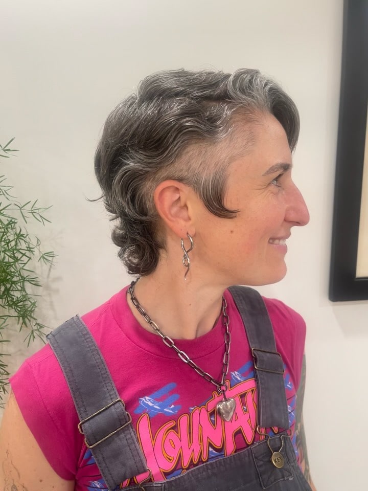 27. Salt-and-Pepper Curly Undercut Pixie Mullet