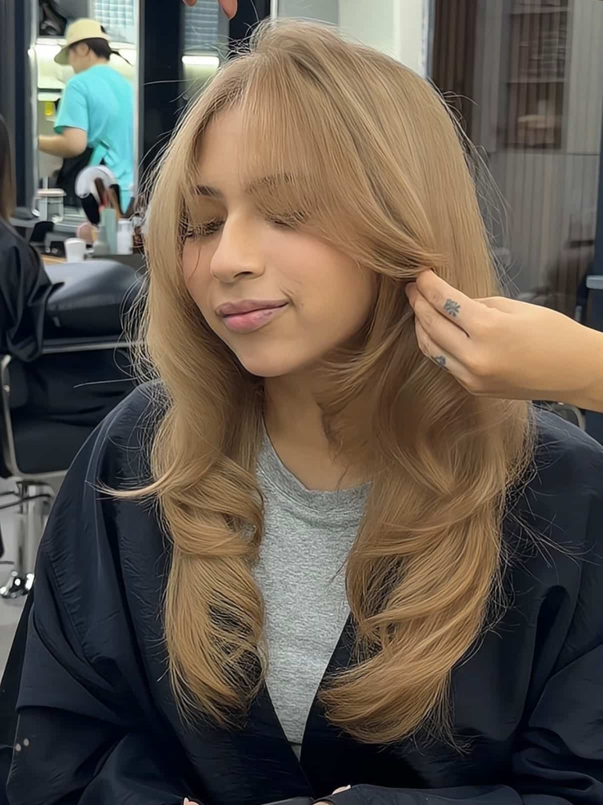 53. Sandy Blonde Blowout with Curtain Bangs