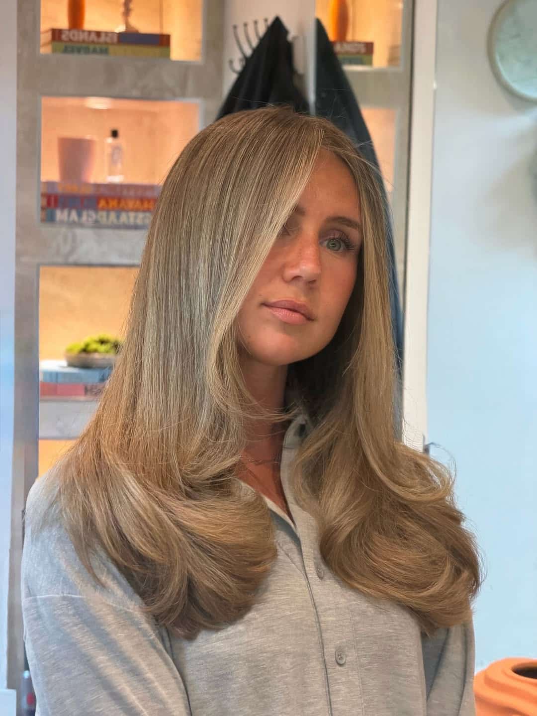 23. Sandy Blonde Blowout with Face-Framing Layers