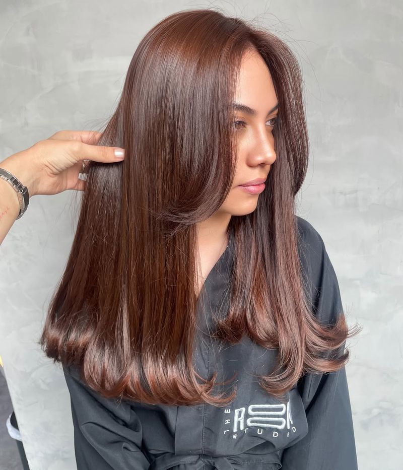 24. Silky Chestnut Layers with Face-Framing Blowout