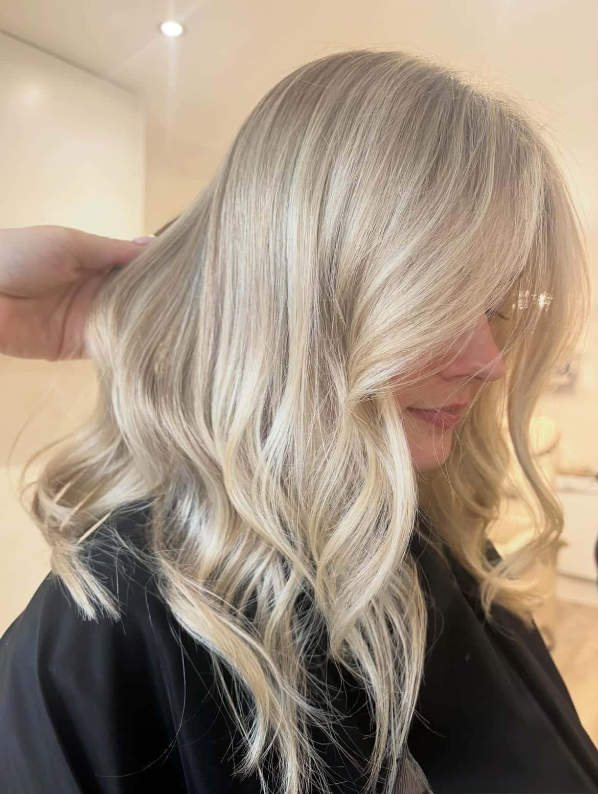 32. Silky Vanilla Waves with Curtain Bangs