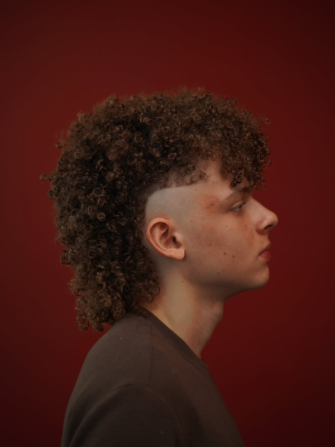 51. Skin Fade Curly Mullet with Heavy Fringe