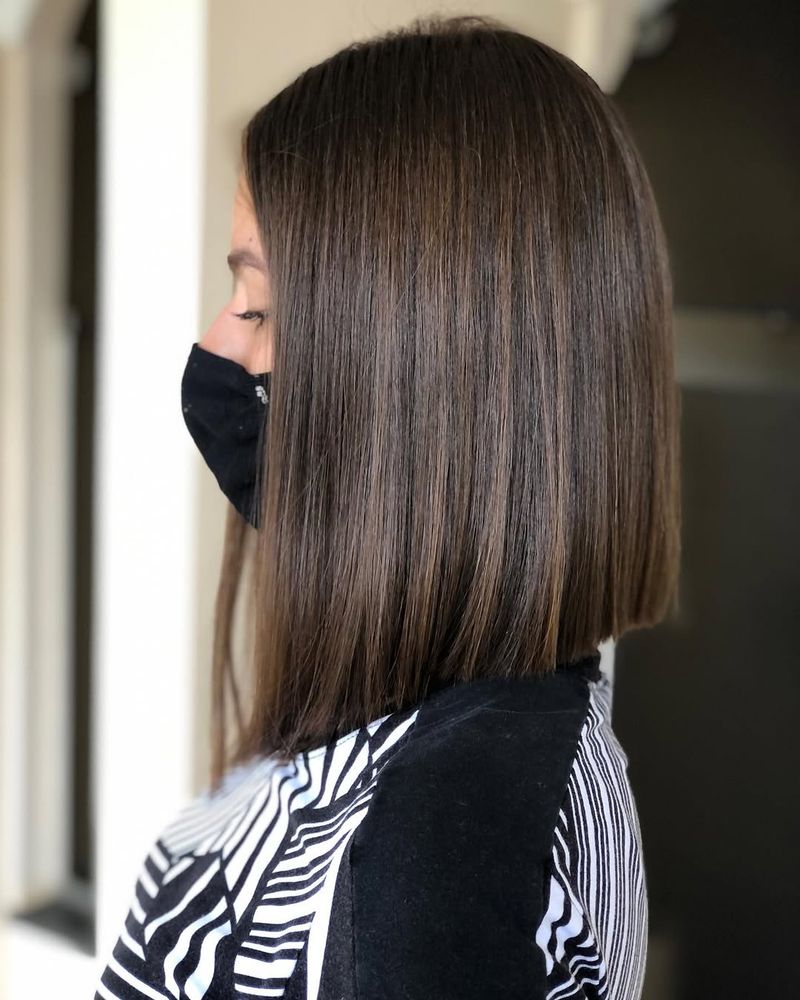 70. Sleek Angled Lob with Subtle Highlights
