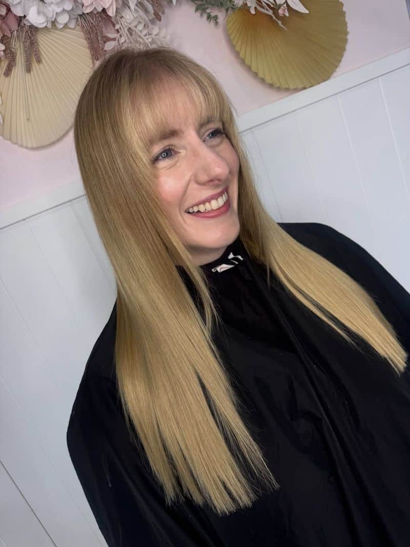 68. Sleek Blonde Blowout with Blended Fringe