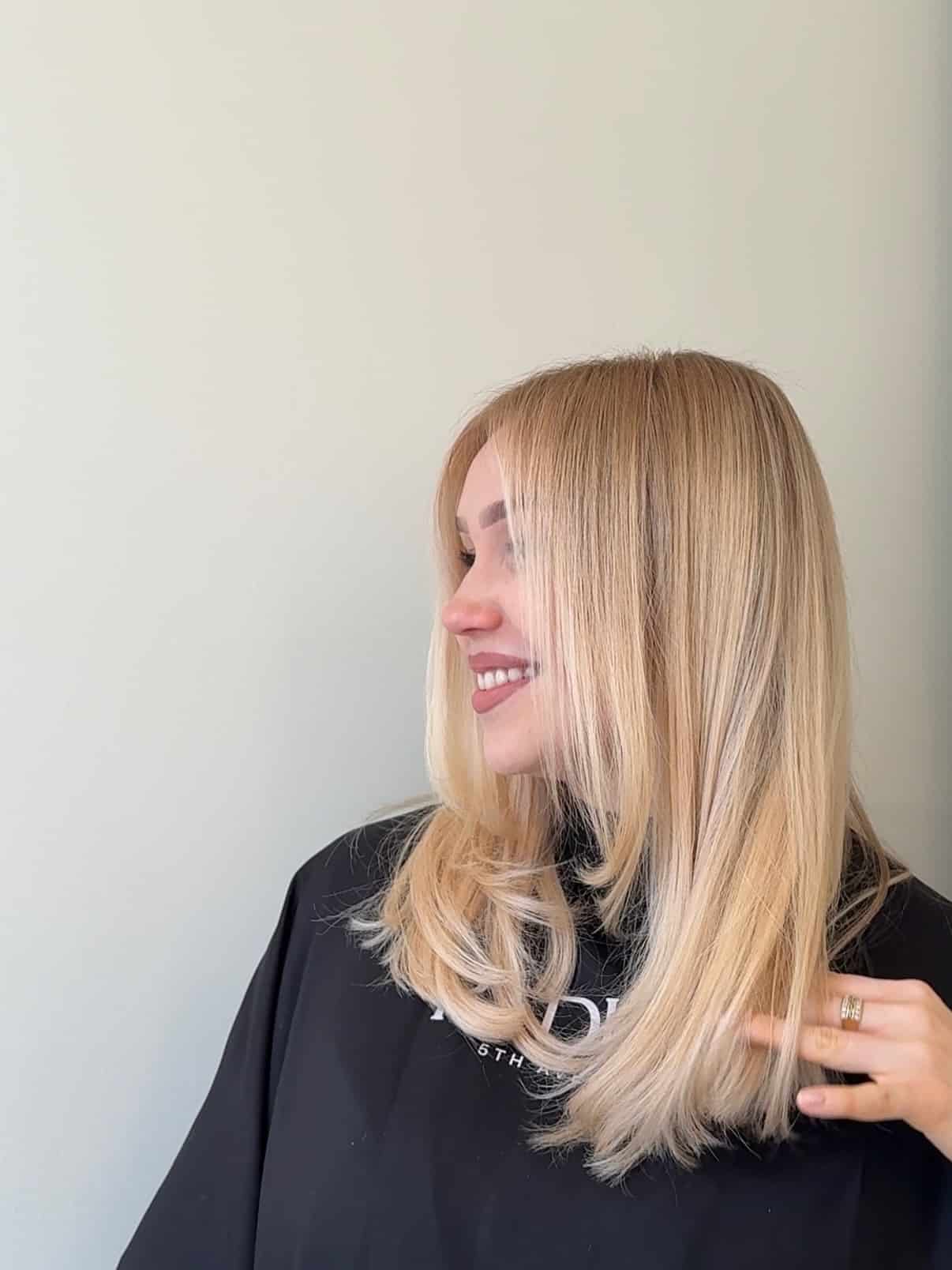 29. Sleek Golden Blonde Blowout with Face-Framing Layers