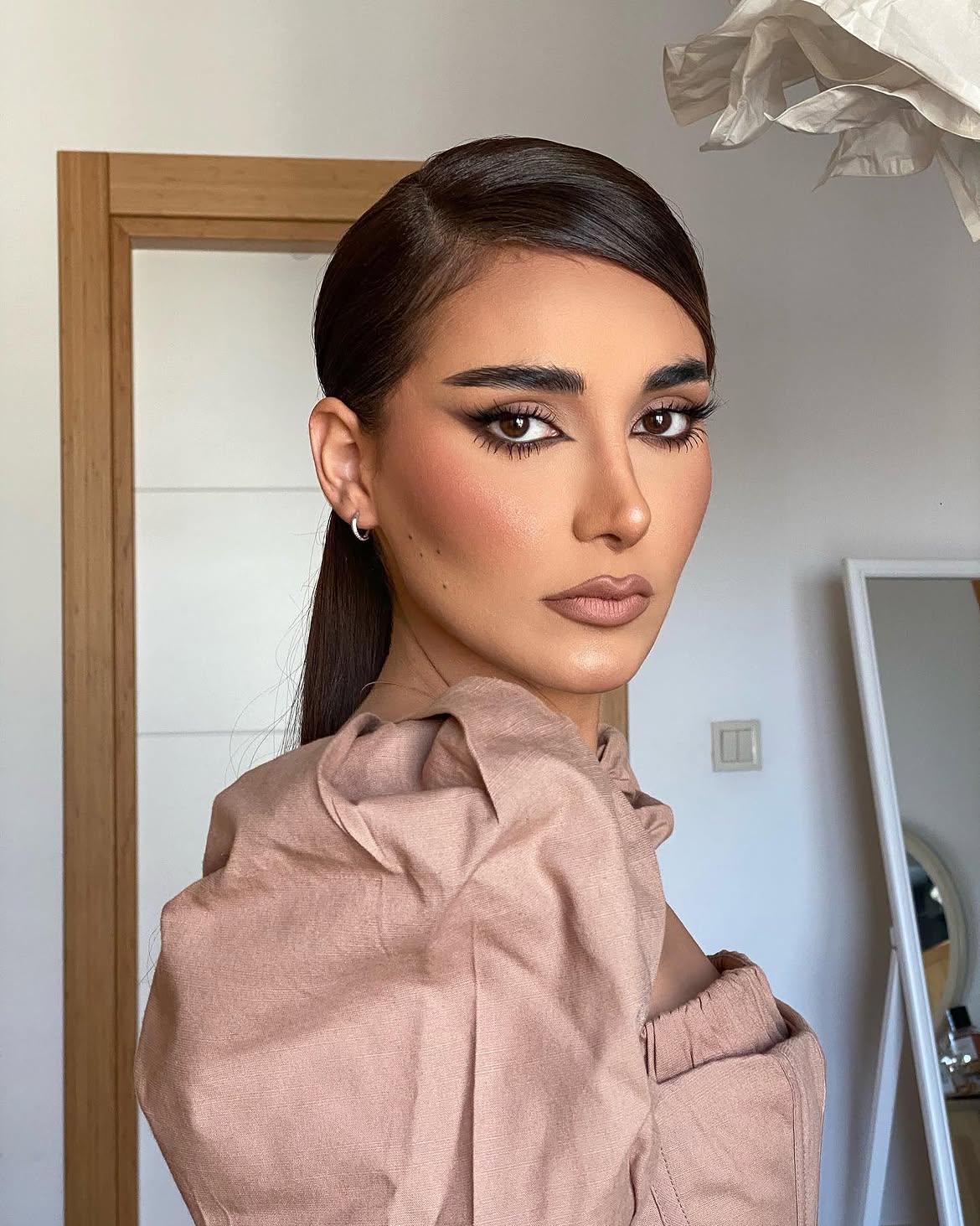 2. Sleek Low Pony with Side Part
