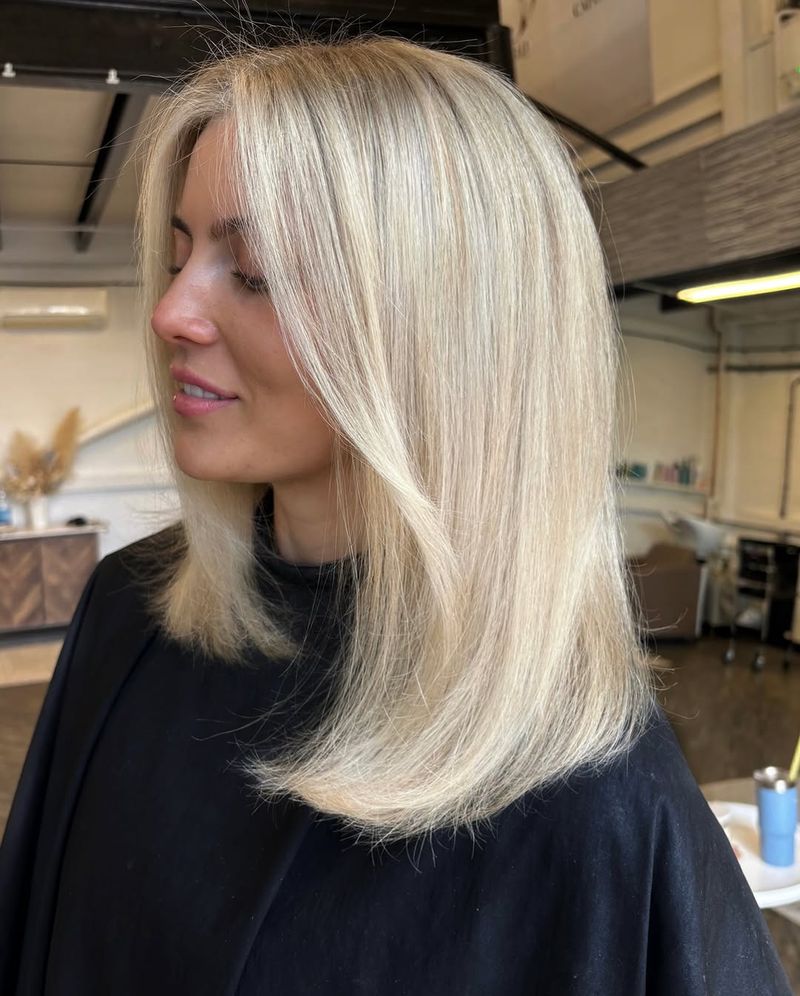 36. Sleek Platinum Lob with Face-Framing Layers