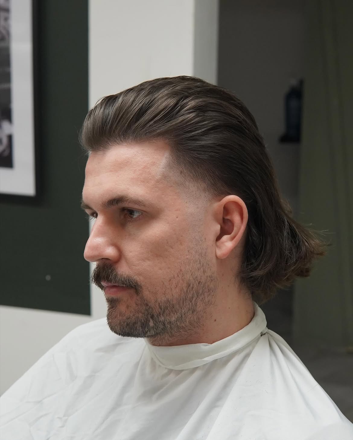 34. Slicked-Back Mullet with Low Taper Fade