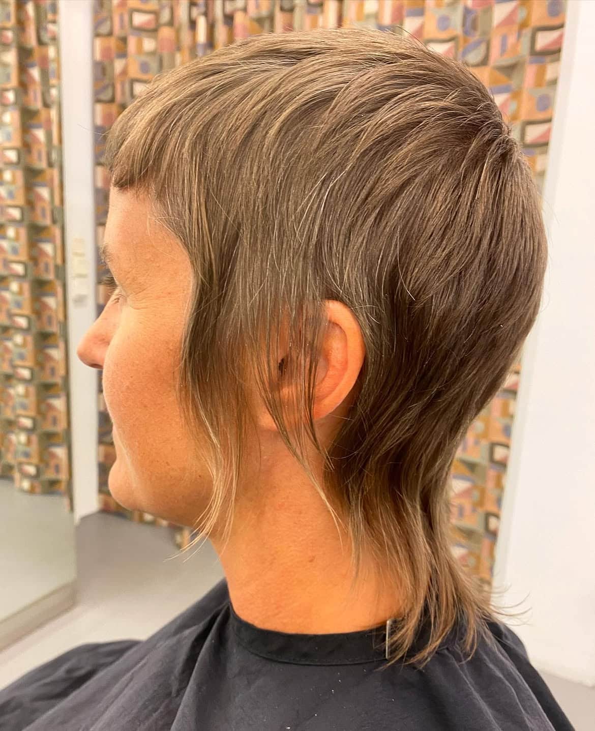23. Soft Ash Brown Pixie Mullet with Wispy Sideburns