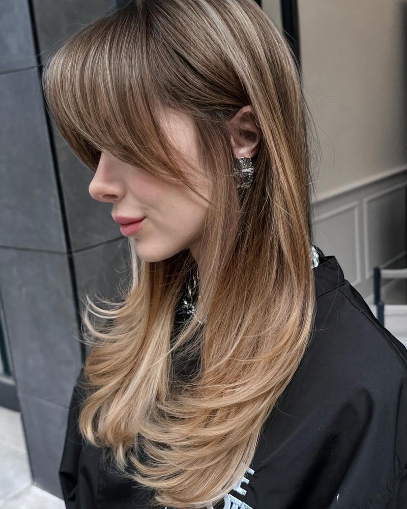 28. Soft Blonde Layers with Sweeping Fringe