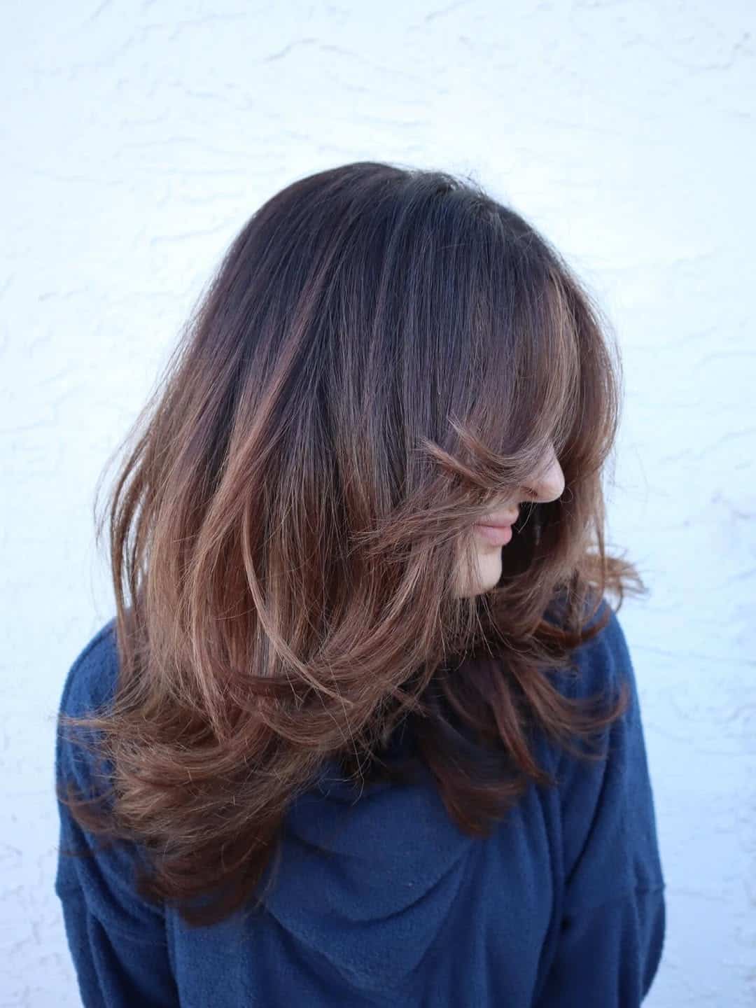 50. Soft Caramel Layers with Curtain Bangs