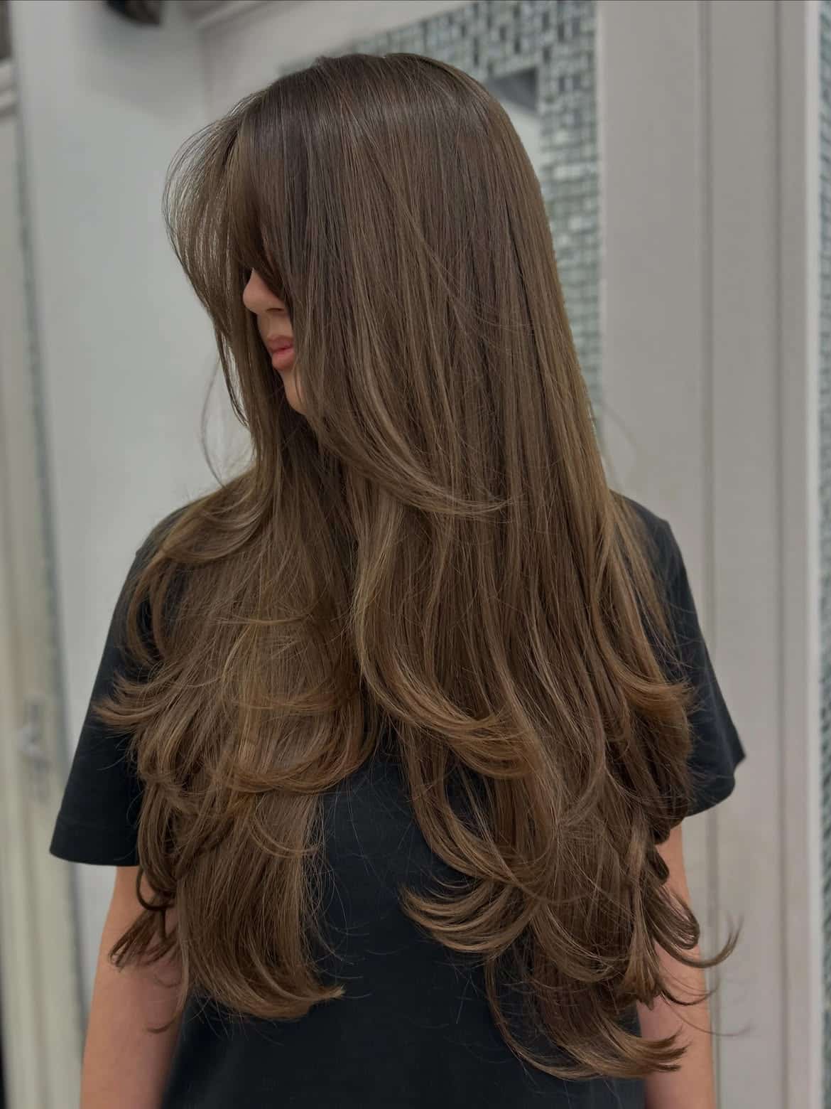 2. Soft Face-Framing Layers with Curtain Bangs