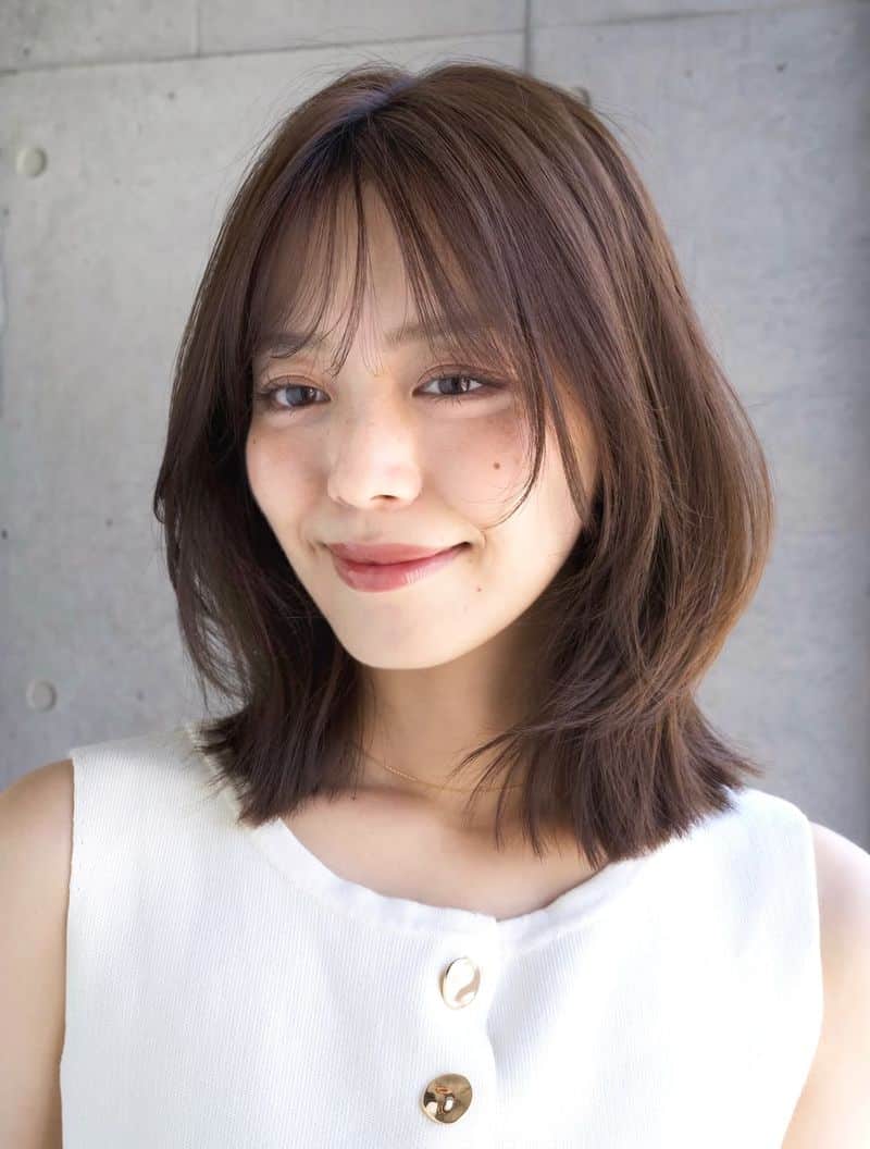 10. Soft Layered Lob with Wispy Bangs